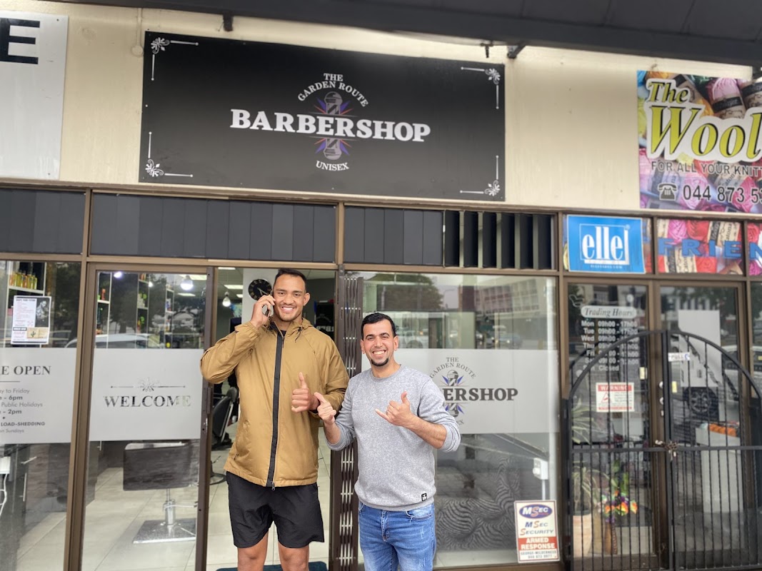 The Garden Route Barber Shop team posing in front of the shop